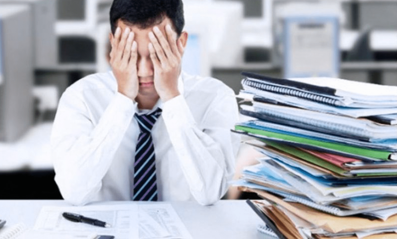 Man with lots of documents on his desk
